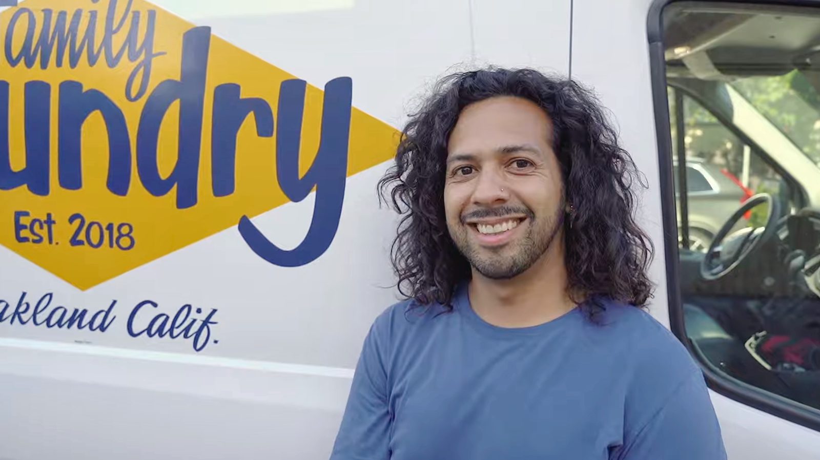 A Family Laundry team member in front of the delivery van