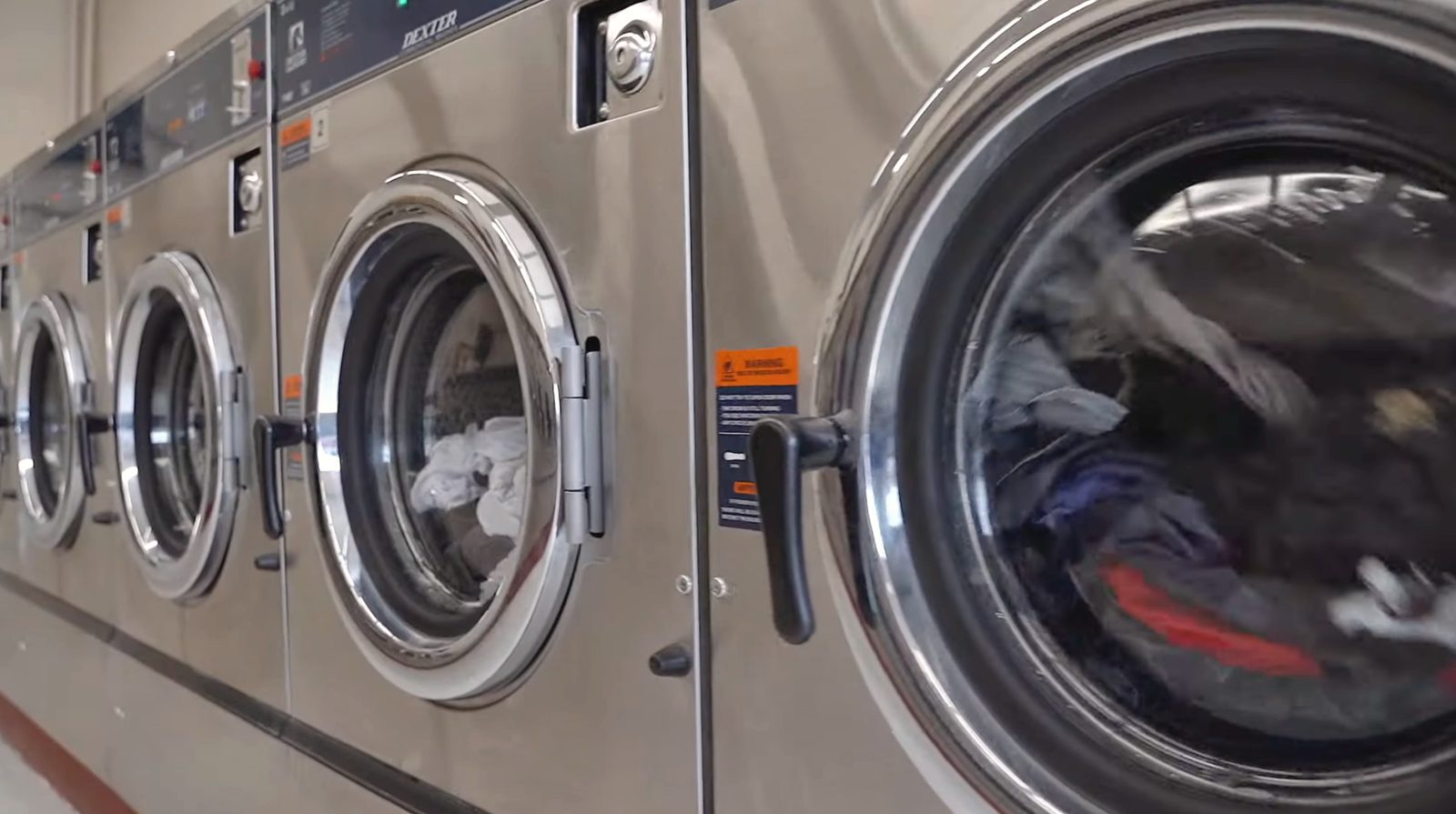 A row of stainless steel washers running at the Family Laundry plant